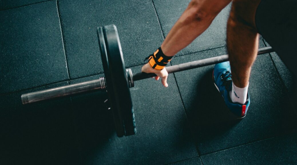 man holding black barbell